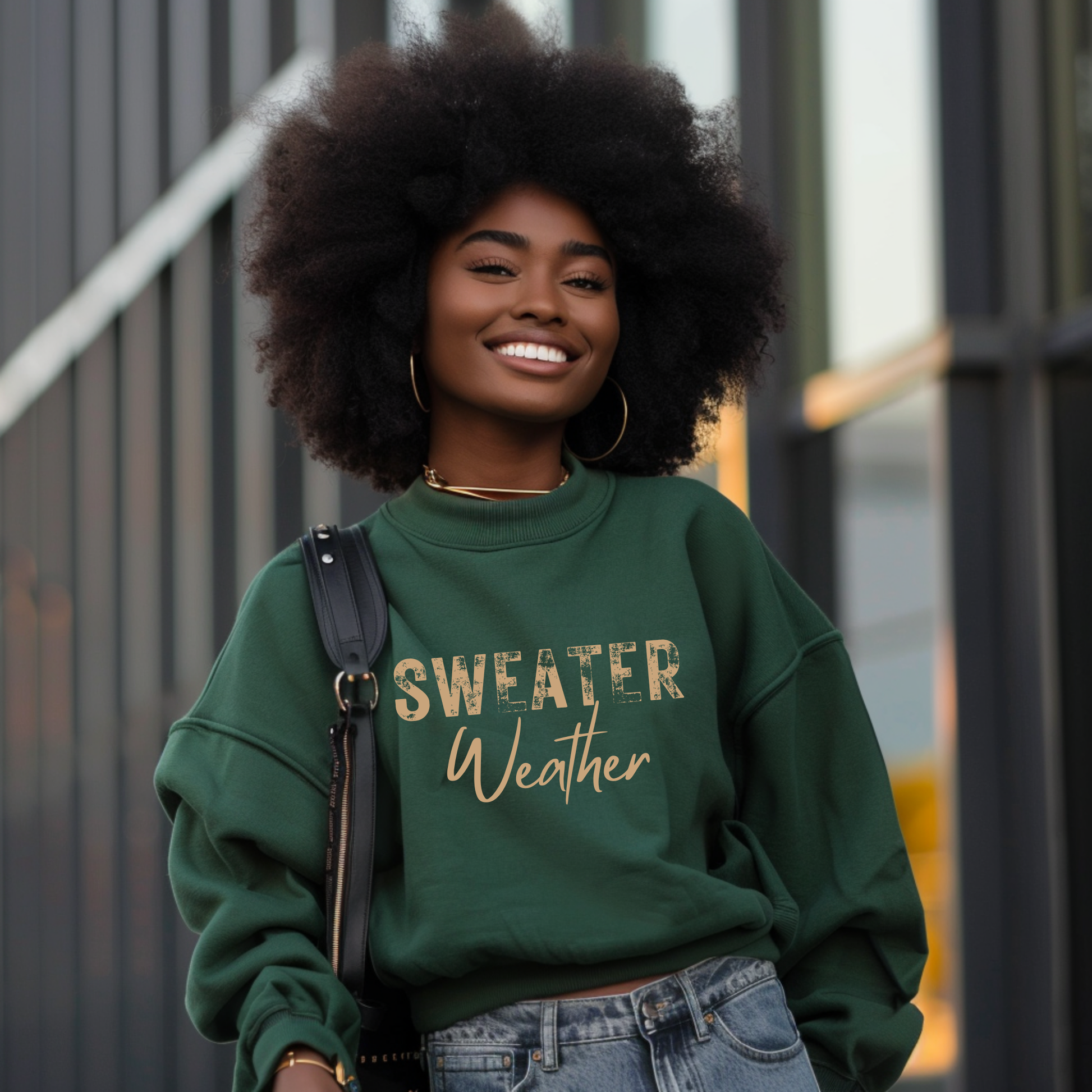 Woman wearing a green sweatshirt with 'Sweater Weather' text, standing outdoors.